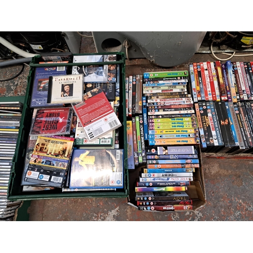 875 - Ten boxes containing a large collection of DVDs and CDs