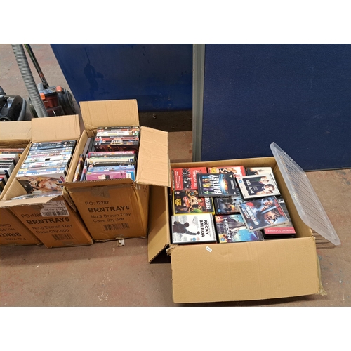 876 - Seven boxes containing a large collection of DVDs