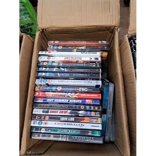 876 - Seven boxes containing a large collection of DVDs