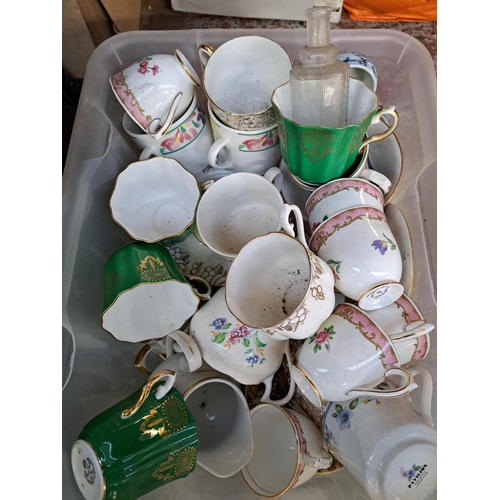 879 - A box containing ceramics and glassware to include vintage glass beer bottles, Royal Grafton tea cup... 