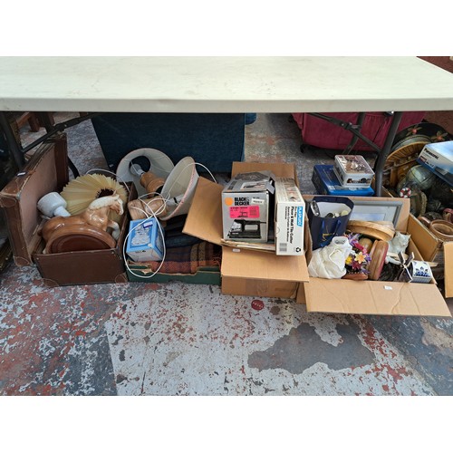 864 - Five boxes and one brown leather suitcase containing treenware, ceramics, cutlery, boxed Black & Dec... 