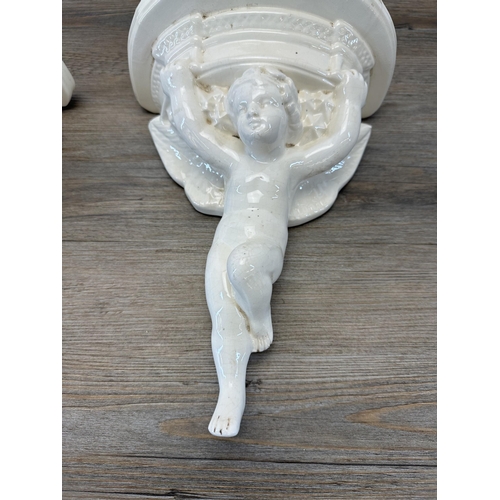 331 - A pair of early 20th century B/Stone Poole England pottery cherub wall brackets inscribed FV - appro... 