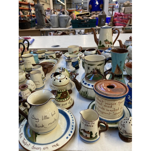 332 - A collection of mottoware pottery to include Watcombe Torquay etc.