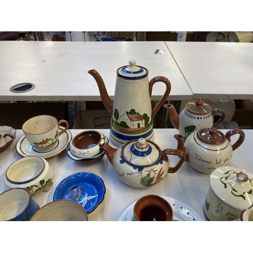 332 - A collection of mottoware pottery to include Watcombe Torquay etc.