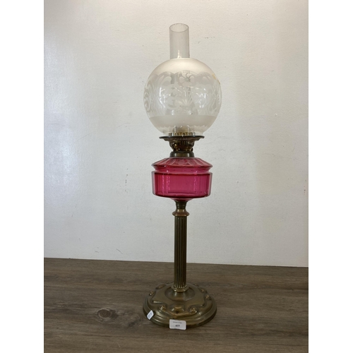 477 - A Victorian Duplex brass and cranberry glass oil lamp with acid etched spherical shade - approx. 70c... 