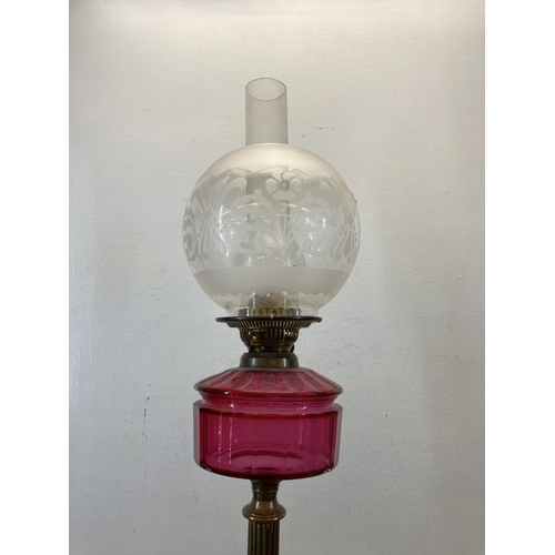 477 - A Victorian Duplex brass and cranberry glass oil lamp with acid etched spherical shade - approx. 70c... 