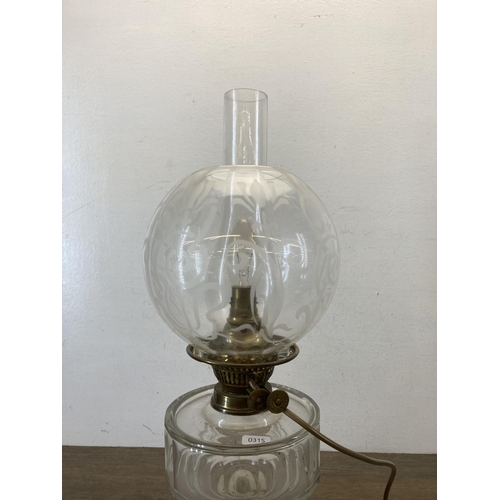 479 - A Victorian Duplex brass and clear glass converted electric oil lamp with acid etched spherical shad... 