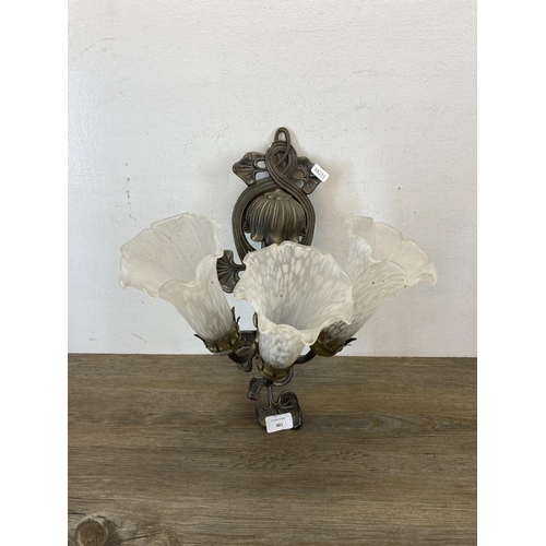 481 - An Art Nouveau style brass effect three branch wall light with frosted glass bell flower shaped shad... 