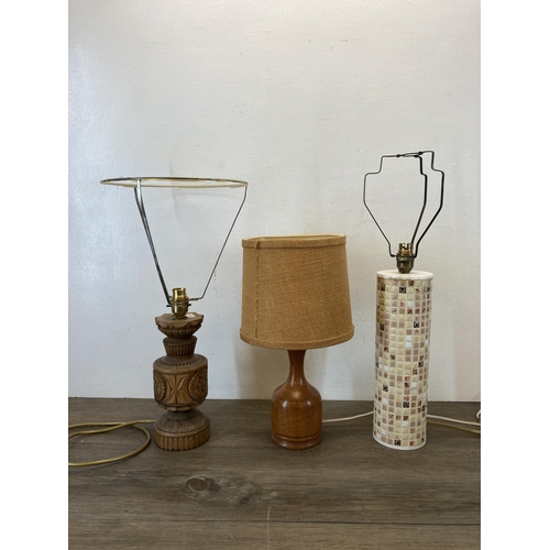 486 - Three table lamps, one teak, one ceramic and one carved hardwood