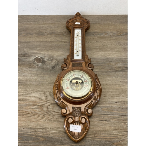 490 - A late 19th/early 20th century carved oak cased barometer - approx. 65cm high