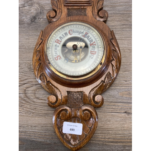 490 - A late 19th/early 20th century carved oak cased barometer - approx. 65cm high