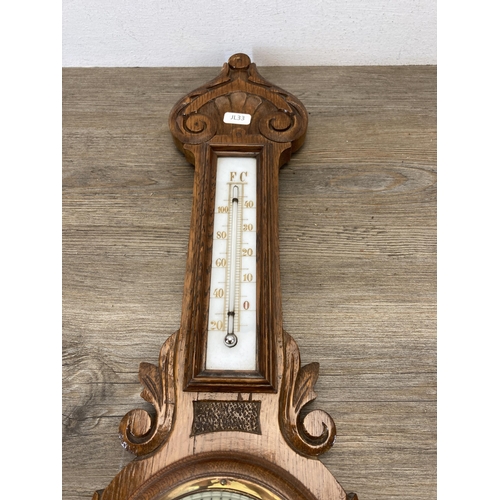 490 - A late 19th/early 20th century carved oak cased barometer - approx. 65cm high