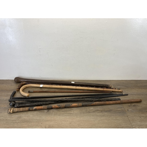 492 - Nine antique and later walking sticks/canes to include carved ebony, Chinese carved bamboo etc.