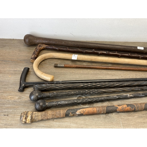 492 - Nine antique and later walking sticks/canes to include carved ebony, Chinese carved bamboo etc.