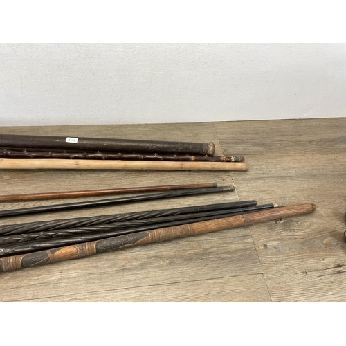 492 - Nine antique and later walking sticks/canes to include carved ebony, Chinese carved bamboo etc.