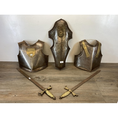 493 - Five items, pair of medieval style breast and back armour plates, two decorative wall hanging brass ... 