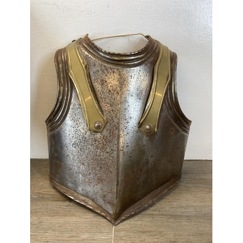 493 - Five items, pair of medieval style breast and back armour plates, two decorative wall hanging brass ... 