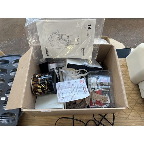 698 - A Singer 14U132 over locker with foot pedal, accessories and instruction manual