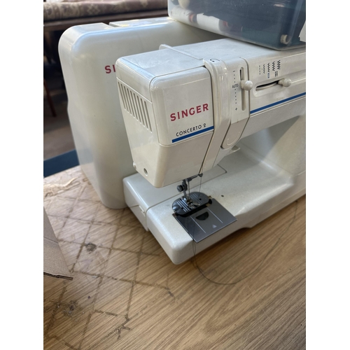 699 - A cased Singer Concerto 2 electric sewing machine with foot pedal, accessories and instruction manua... 