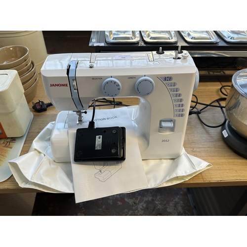 704 - A Janome 2032 electric sewing machine with foot pedal, cover and instruction manual