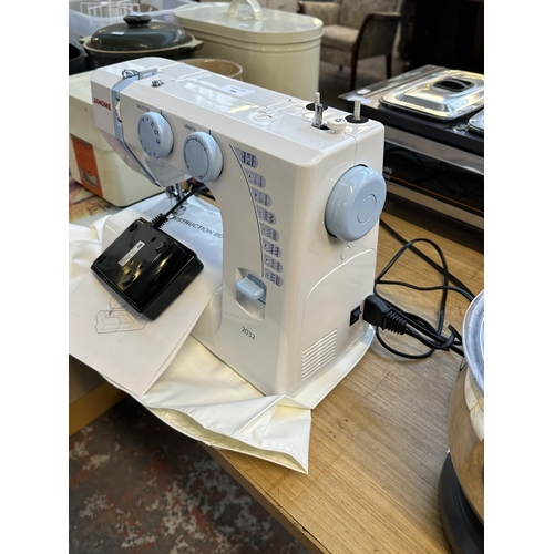 704 - A Janome 2032 electric sewing machine with foot pedal, cover and instruction manual