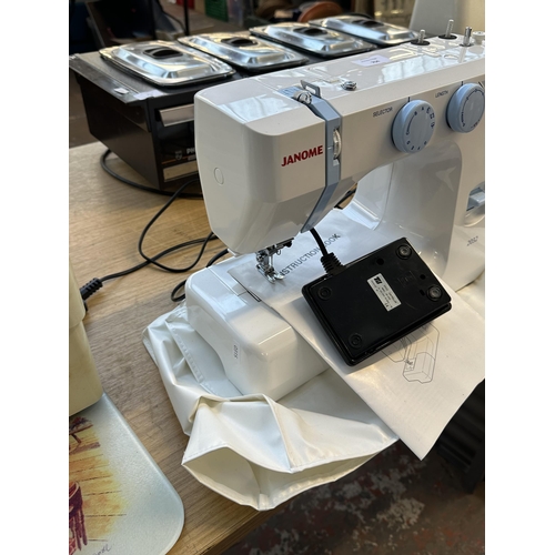 704 - A Janome 2032 electric sewing machine with foot pedal, cover and instruction manual