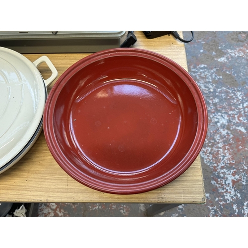 708 - Two items, one Emile Henry Tagine and one enamelled cast iron shallow casserole