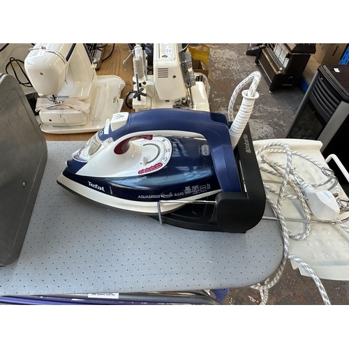 709 - Four items, one Tefal Aqua Speed steam iron with Brabantia stand, one Brabantia ironing board, one B... 