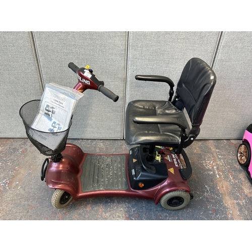 740 - A Sterling Little Gem 4 wheel electric mobility scooter with key, battery charger and owner's manual