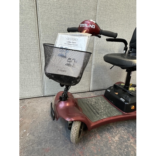 740 - A Sterling Little Gem 4 wheel electric mobility scooter with key, battery charger and owner's manual