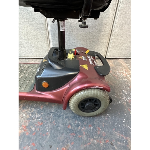 740 - A Sterling Little Gem 4 wheel electric mobility scooter with key, battery charger and owner's manual