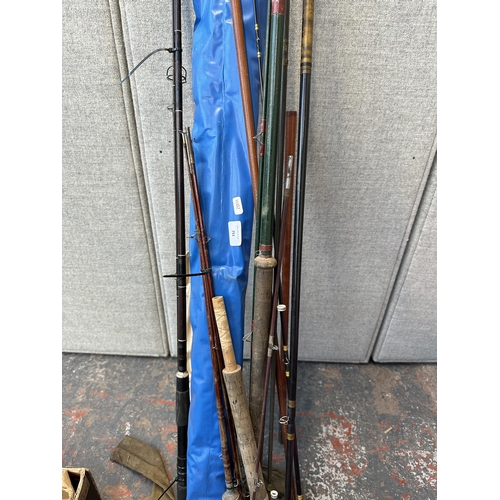 751 - A collection of vintage fishing rods to include split cane etc.