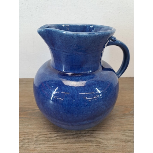 324A - An early 20th century Fremington Pottery Barnstaple blue glazed terracotta jug - approx. 19cm high