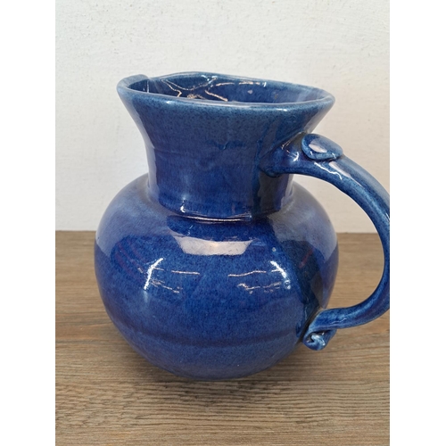 324A - An early 20th century Fremington Pottery Barnstaple blue glazed terracotta jug - approx. 19cm high