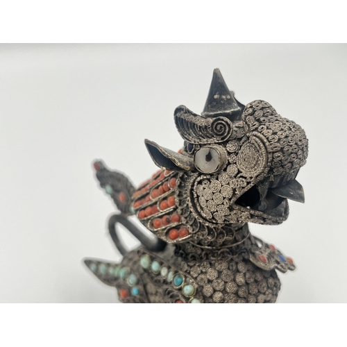 2140 - A Burmese .925 silver filigree chinthe figurine with inset coral and turquoise decoration