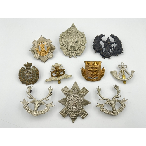 Ten military cap badges