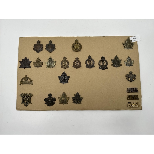 2290 - A collection of military cap badges