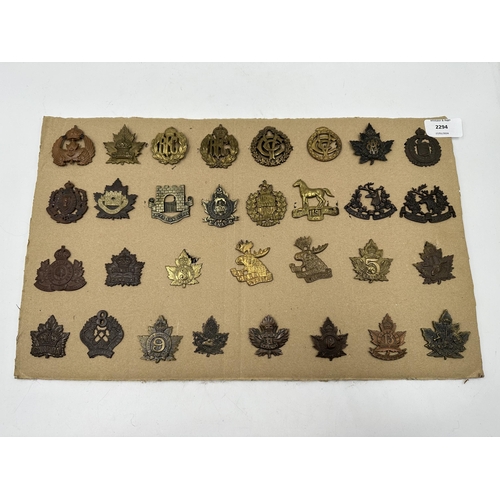 2294 - A collection of military cap badges