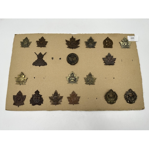 2295 - A collection of military cap badges