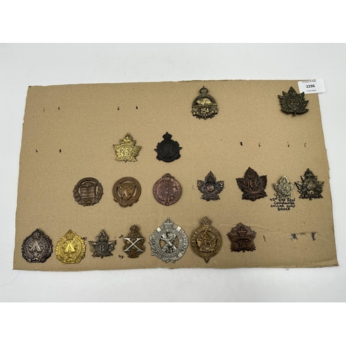 2296 - A collection of military cap badges