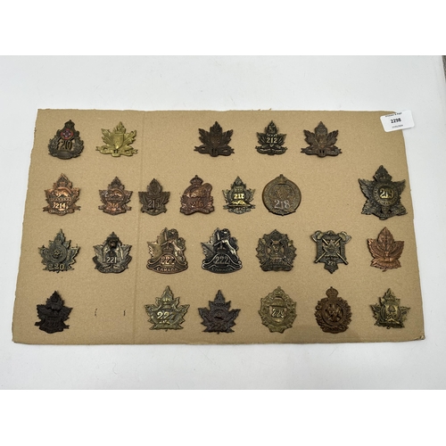 2298 - A collection of military cap badges