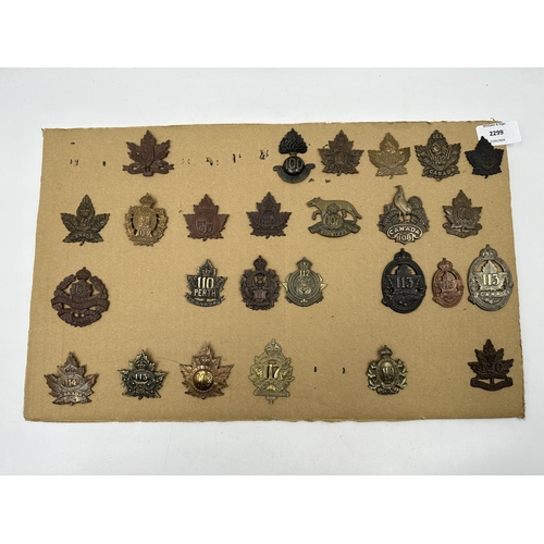 2299 - A collection of military cap badges