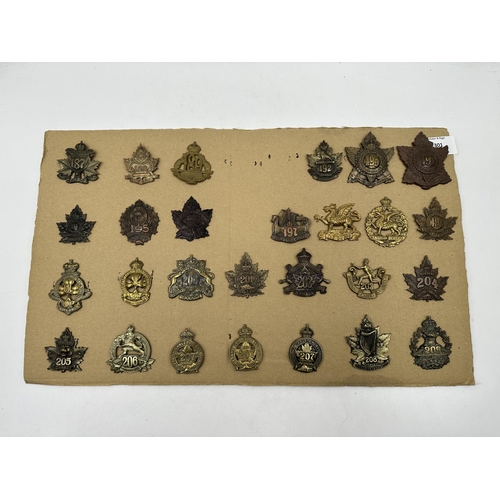 2301 - A collection of military cap badges