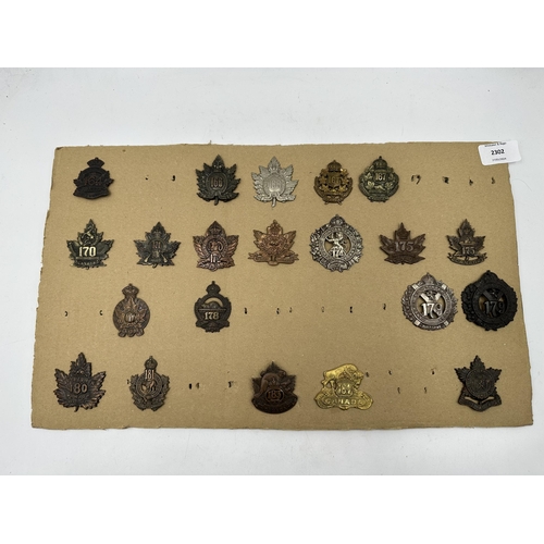 2302 - A collection of military cap badges