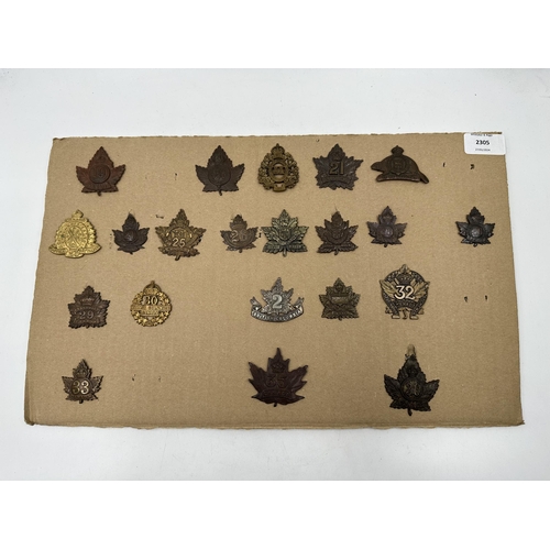 2305 - A collection of military cap badges