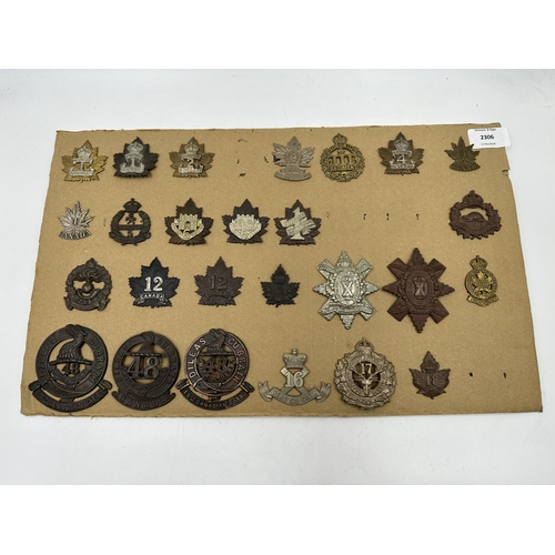 2306 - A collection of military cap badges