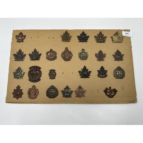 2307 - A collection of military cap badges