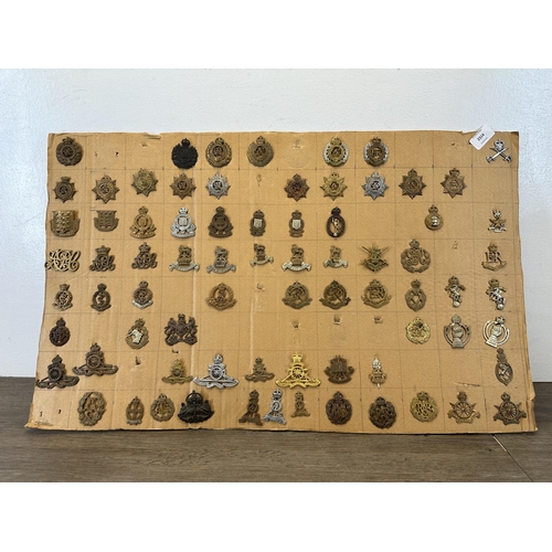 2314 - A large collection of military cap badges