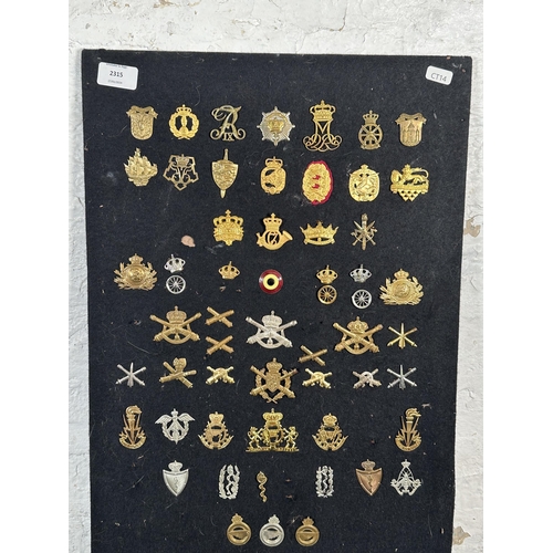 2315 - A large collection of military cap badges and shoulder titles