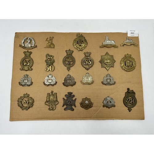 2317 - A collection of military cap badges